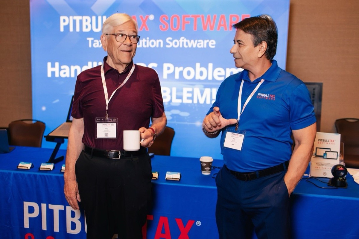Jose Alfaro talking with a tax practitioner at the PitBullTax® Software booth at the previous conference.
