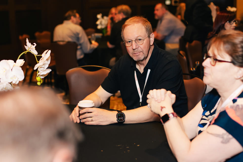 Attendees in conversation around coffee tables at the Hard Rock Hollywood, 2024.