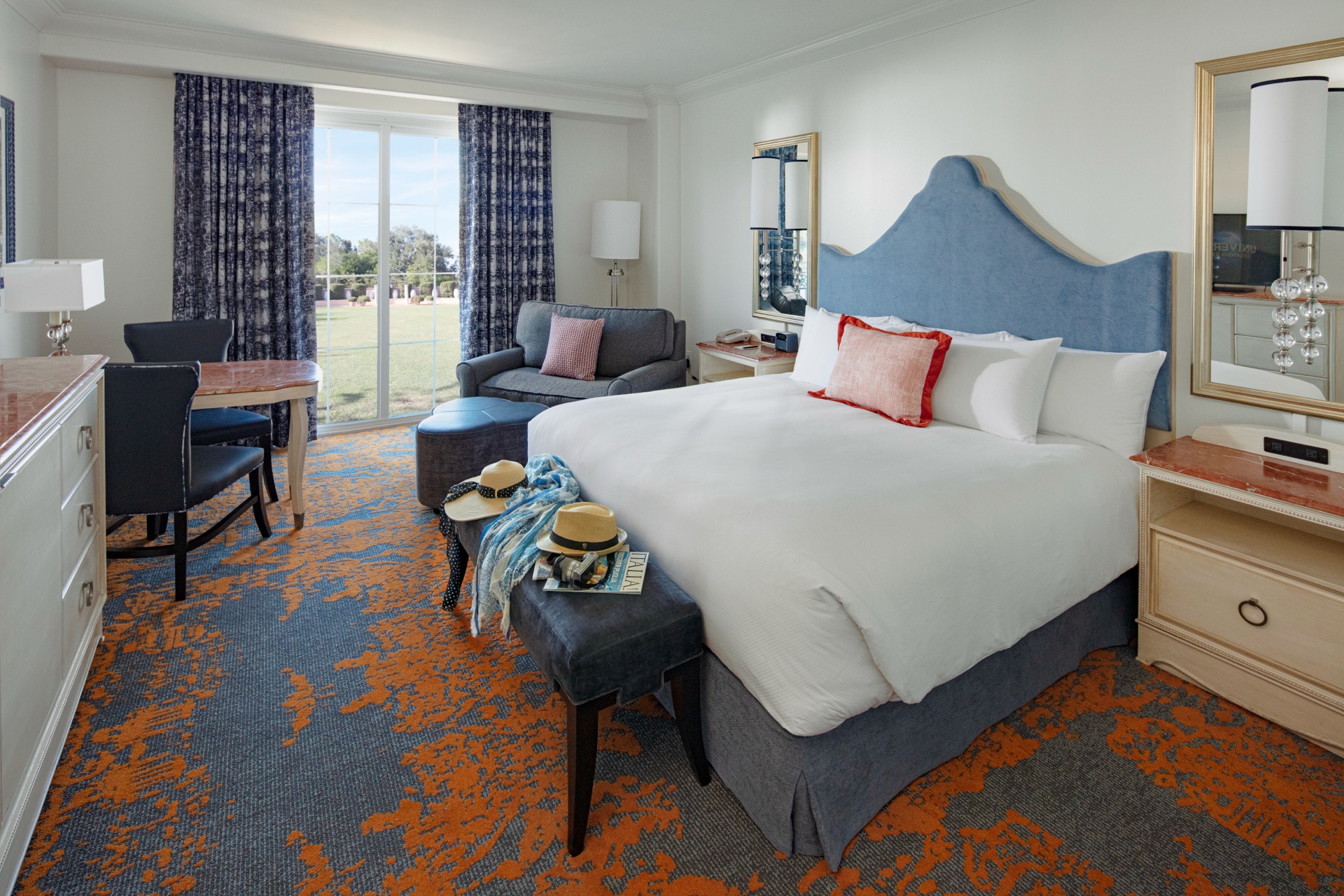 King-bed guest room with Italian-village harbor views at Loews Portofino Bay.