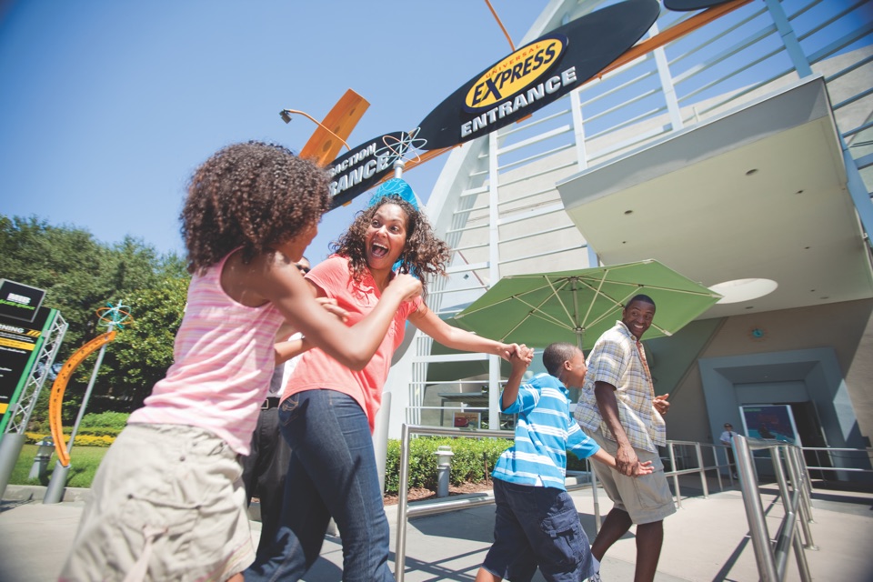 Family running toward the EXPRESS ENTRANCE sign at Universal Studios Florida.